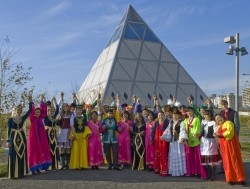 Representatives of different nationalities pose in front of the Pyramid of Peace in Astana, Kazakhstan. The Pyramid, constructed in 2006, represents country's spirit of tolerance and peace.