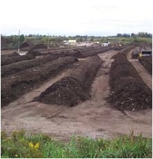 Organic material is delivered to a composting facility and mixed with seed. It is then spread across tunnels that heat up the material to enhance the natural decay process. PHOTO: COURTESY PLASCO ENERGY GROUP