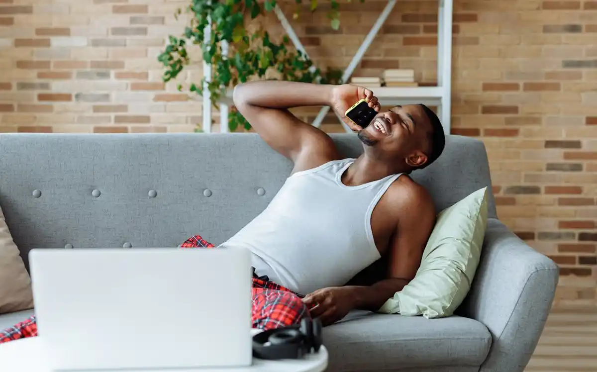 A couple relaxing on the sofa with a laptop during a cozy evening at home.